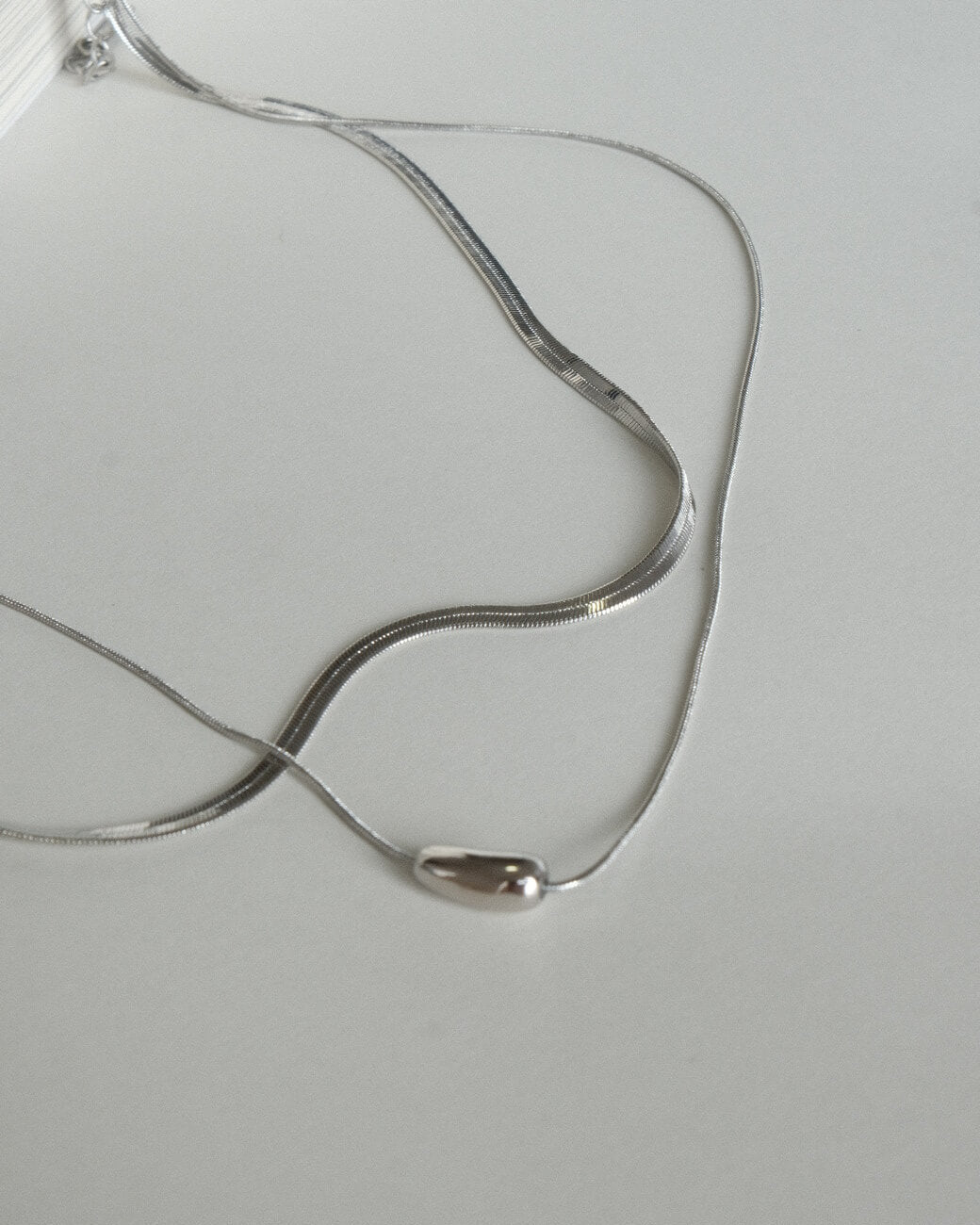 Two-layer snake chain necklace with a small, polished tear drop pendant - detail - SWEEKU jewelry