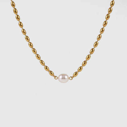 A gold chain necklace with a single white pearl pendant, centered against a light gray background.