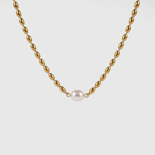 A gold chain necklace with a single white pearl pendant, centered against a light gray background.