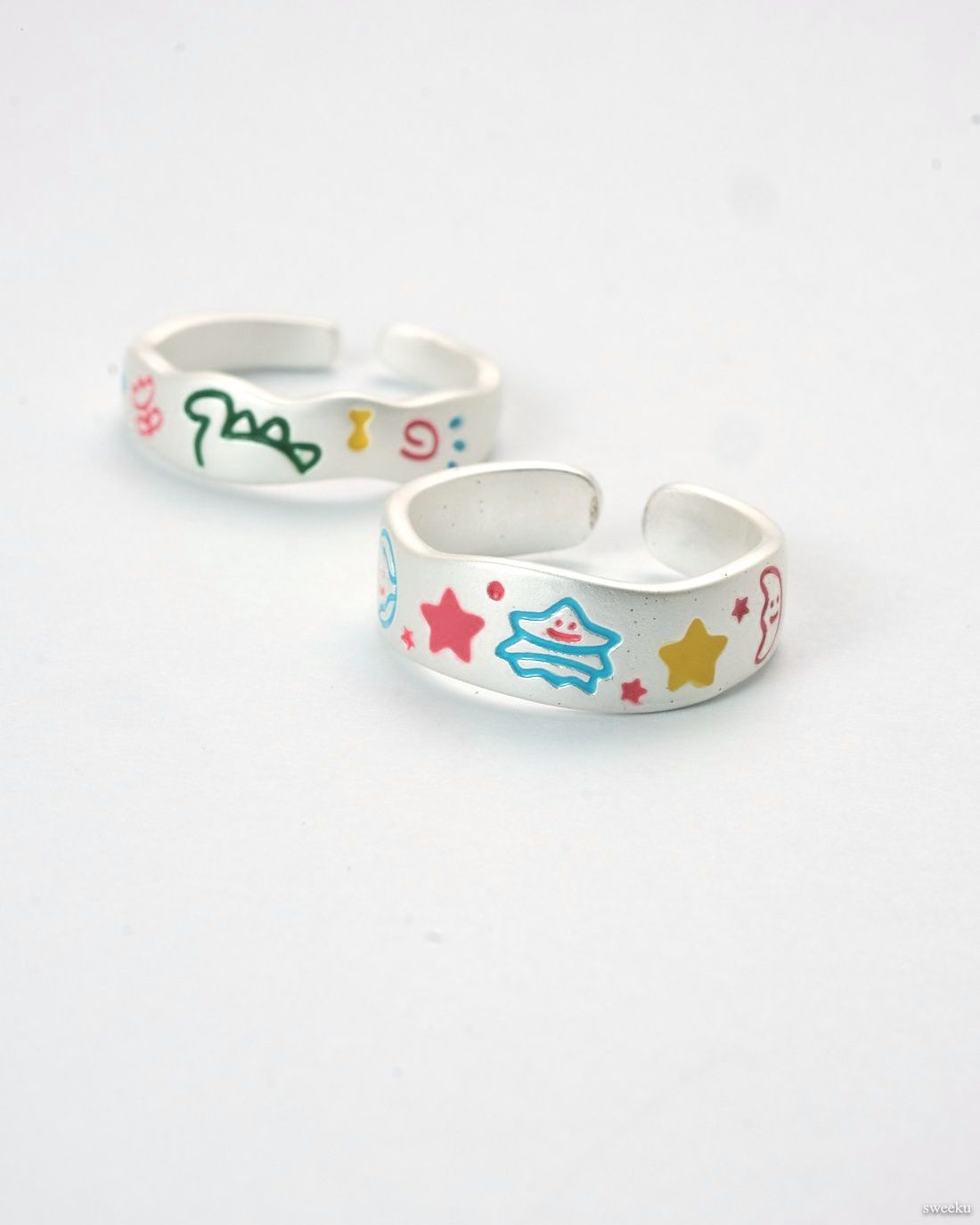 Cosmic Duo Ring Set featuring two adjustable silver enamel rings with colorful designs