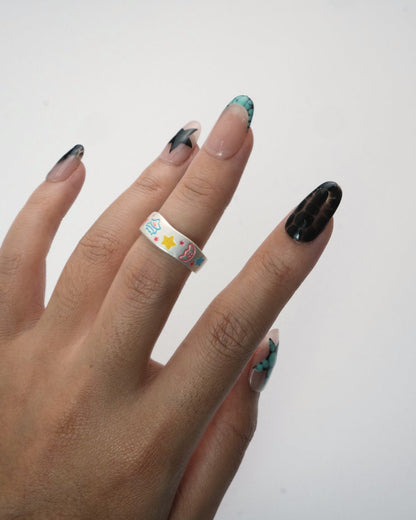 Cosmic Pop Ring worn on hand, playful silver enamel ring with bright designs