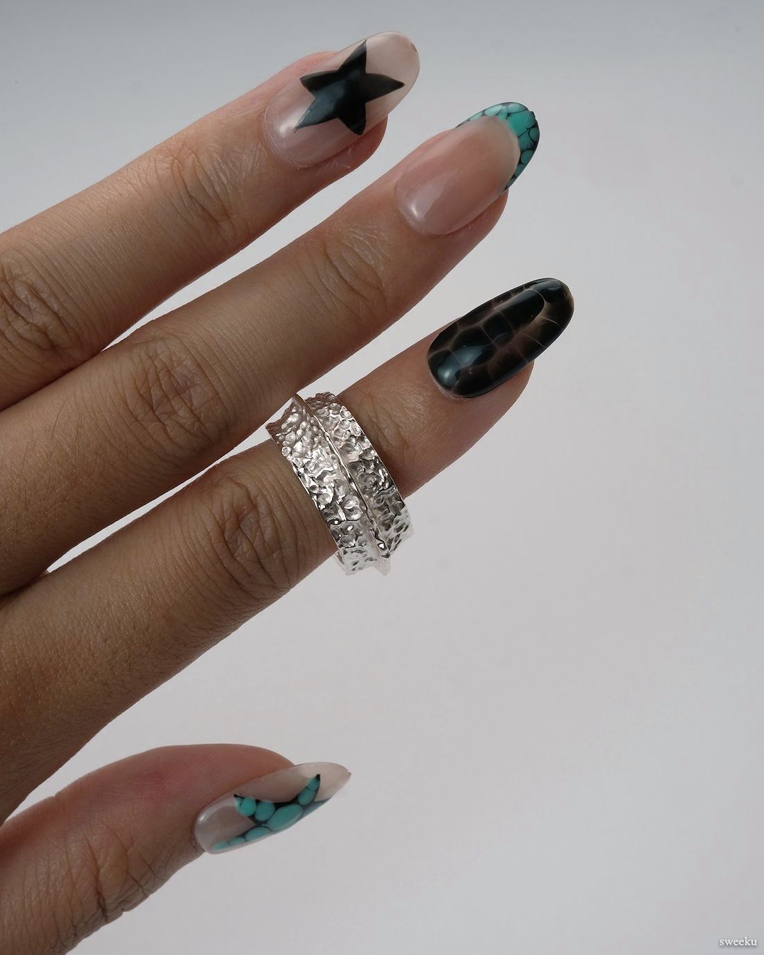 Crater Band Ring worn on hand, silver textured statement ring