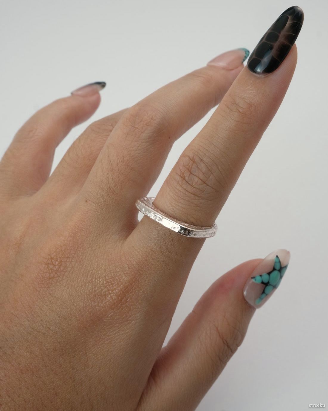 Echo Form Ring Set worn on hand showing open-form and textured silver bands