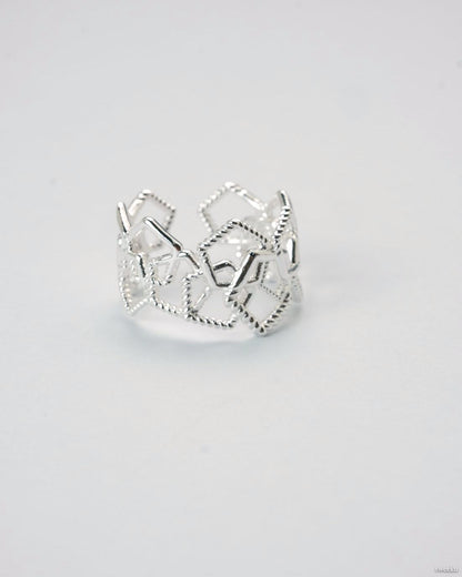 Adjustable silver geometric open lattice ring on white background