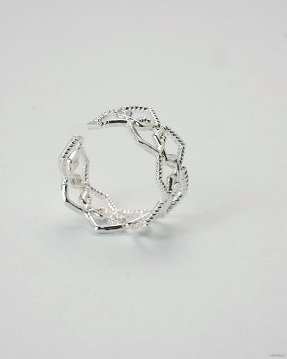 Adjustable silver geometric open lattice ring on white background