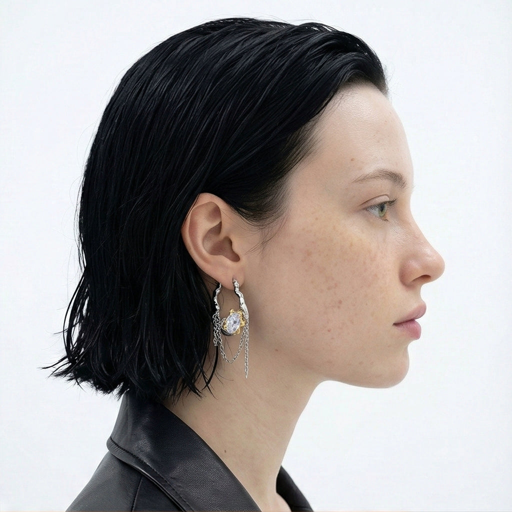 Model wearing melting metal chain dangle earrings with sculptural finish