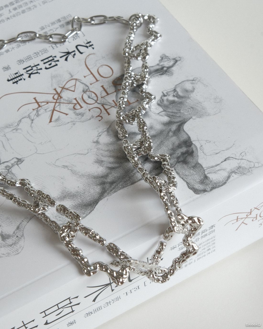 silver molten texture chain necklace on book background, adjustable length