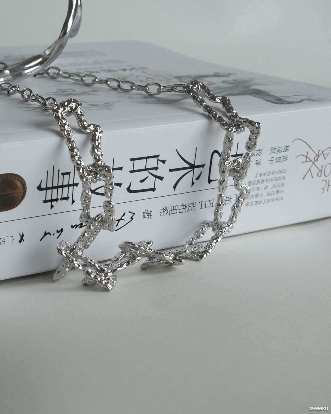 silver molten texture chain necklace on book background, adjustable length