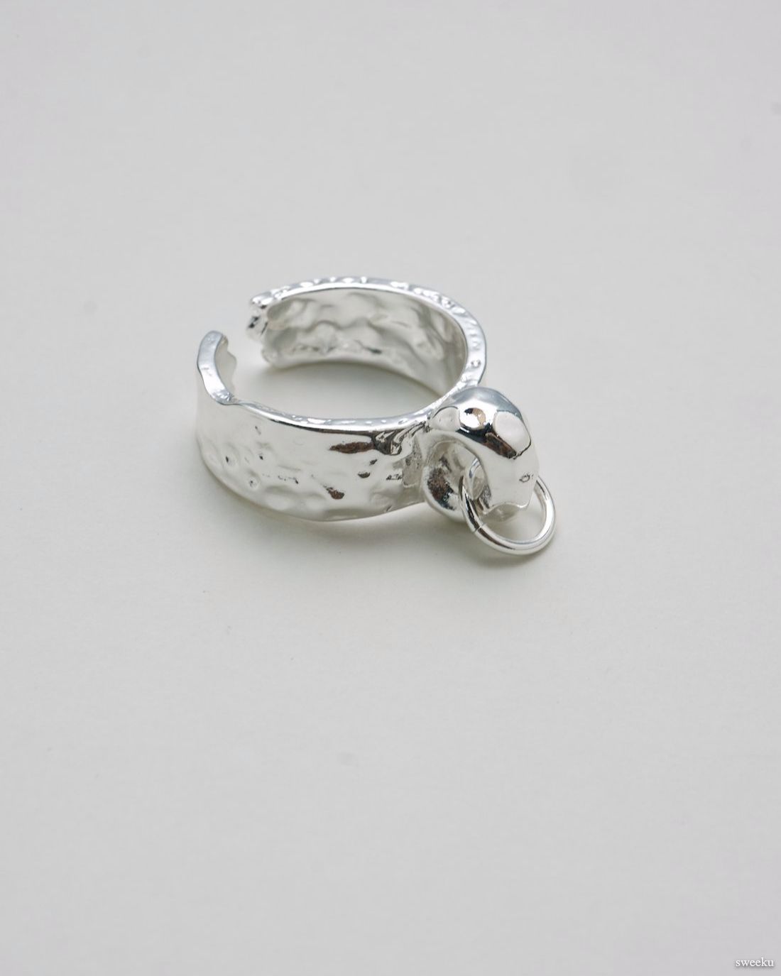 Single molten-texture silver ring featuring a raised orb centerpiece.