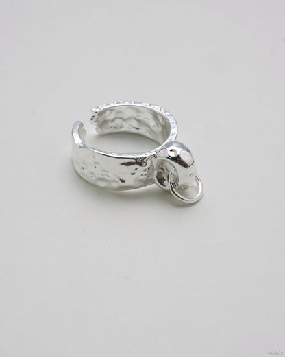 Single molten-texture silver ring featuring a raised orb centerpiece.