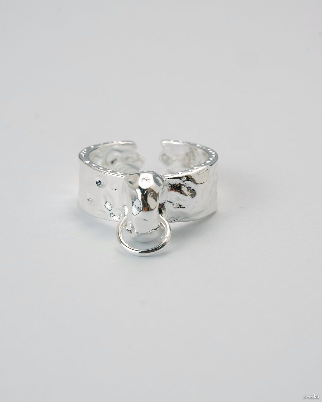 Adjustable molten texture silver plated ring with loop charm on white background