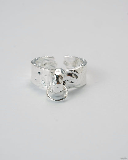 Adjustable molten texture silver plated ring with loop charm on white background