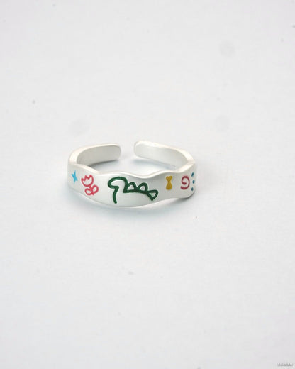 Adjustable silver enamel ring with colorful doodle design