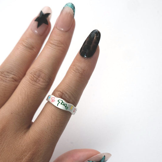 Neon Whirl Ring worn on hand, fun abstract enamel pattern on silver band