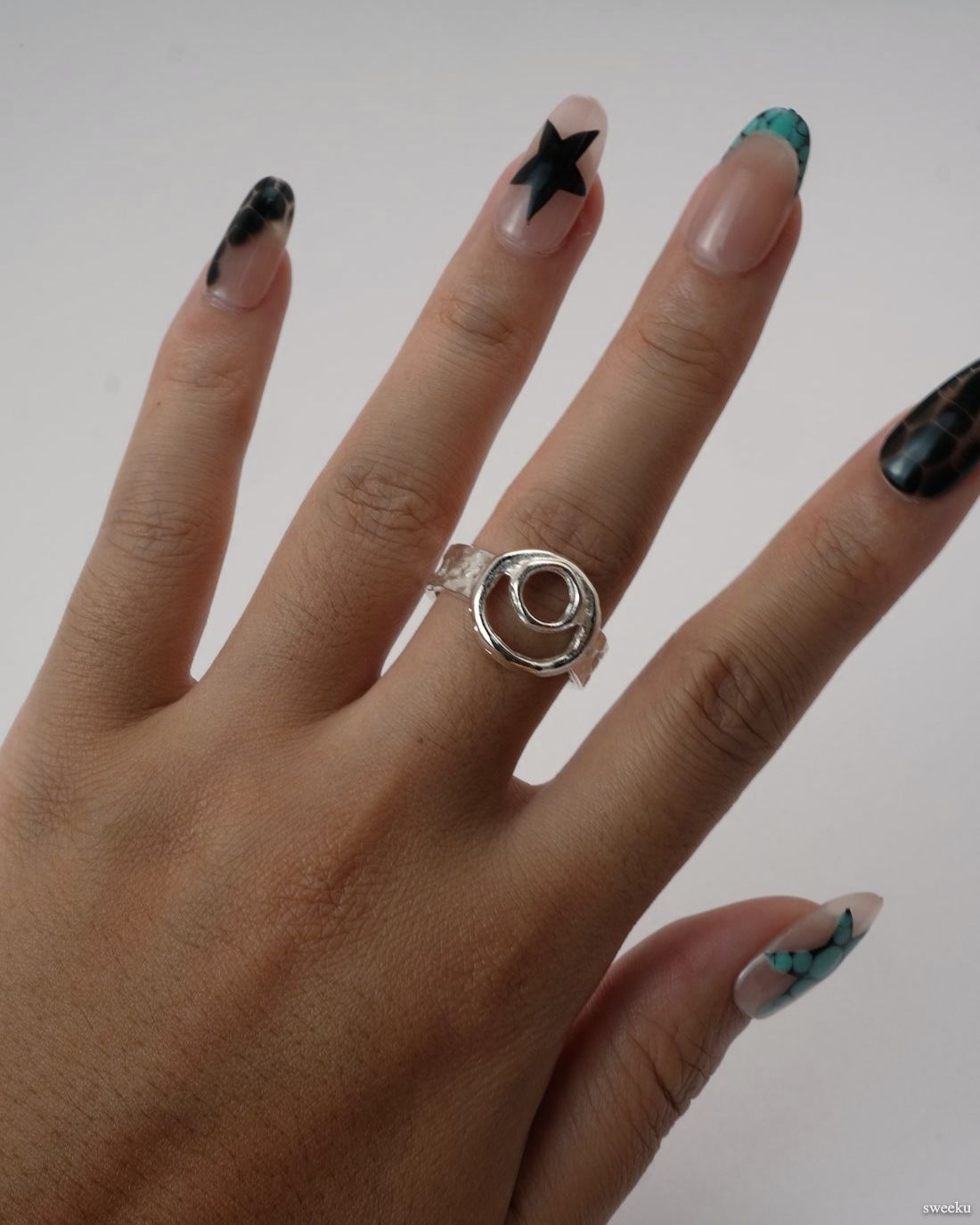 Orbit Flow Ring worn on hand, adjustable sculptural silver ring