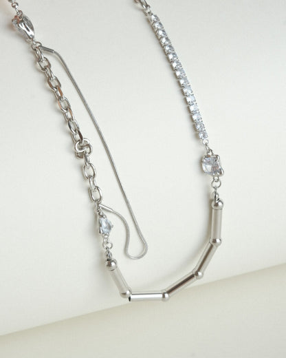 Asymmetrical pearl and zirconia necklace with a mix of chains, beads, and polished bars - stones detail - front view - SWEEKU jewelry