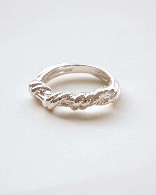 Braided sculptural metal ring with a twisted design and polished finish – front view – SWEEKU jewelry