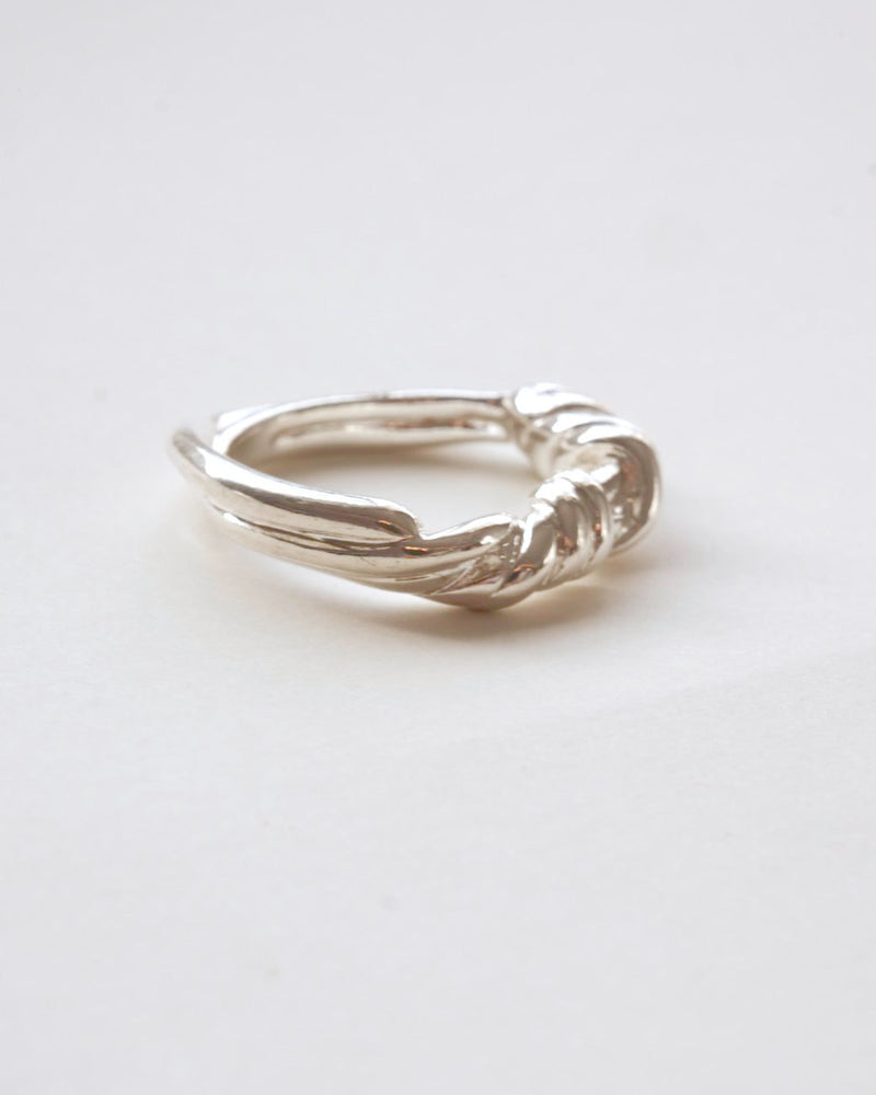 Braided sculptural metal ring with a twisted design and polished finish – side view – SWEEKU jewelry