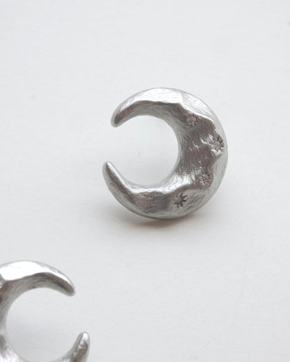 Pair of celestial crescent moon stud earrings crafted from textured copper with embedded stars and silver posts – detail - side view – SWEEKU jewelry