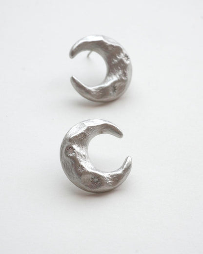 Pair of celestial crescent moon stud earrings crafted from textured copper with embedded stars and silver posts – front view – SWEEKU jewelry