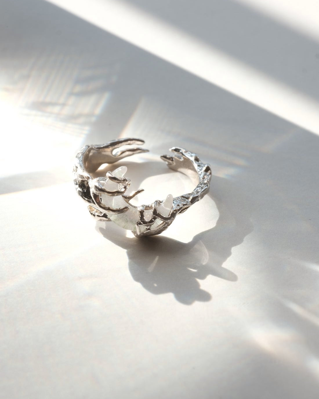 Dragon claw ring with an adjustable open band and a clear crystal centerpiece – front view – SWEEKU jewelry