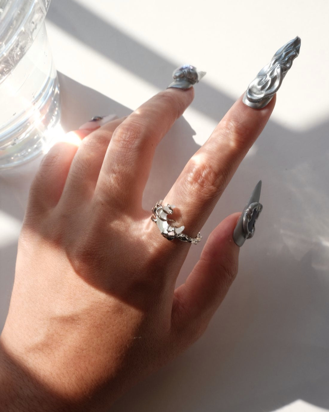 Model wearing dragon claw ring with an adjustable open band and a clear crystal centerpiece – top view – SWEEKU jewelry