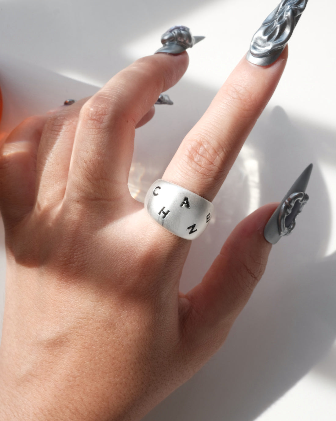 Model wearing engraved chunky copper band ring with a brushed finish and adjustable open band – front view – SWEEKU jewelry
