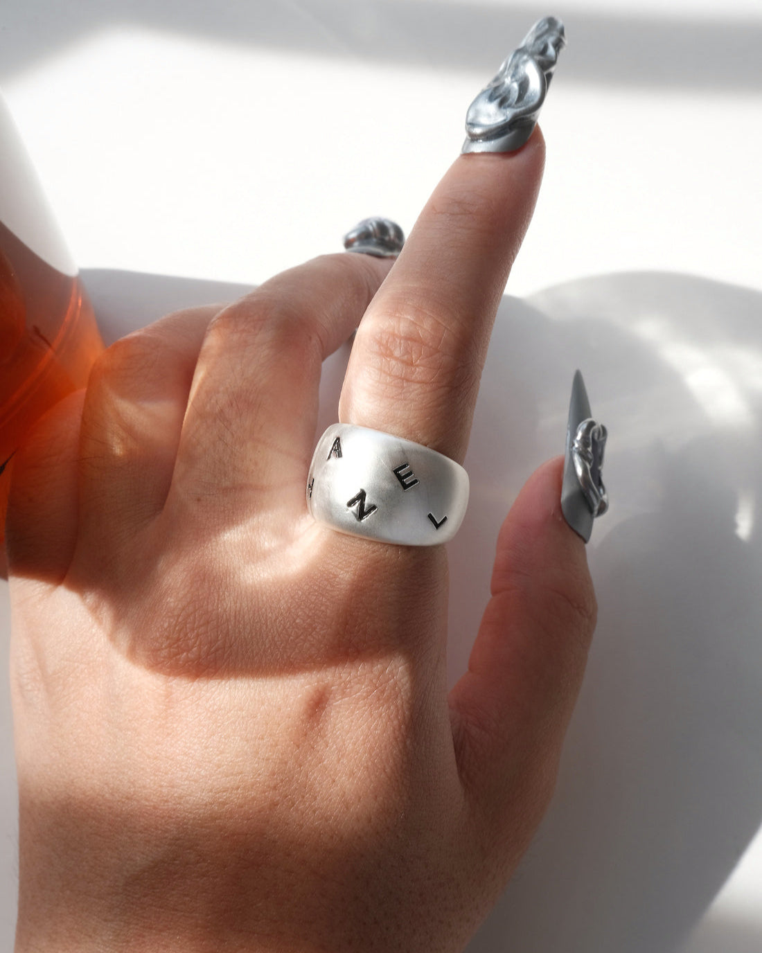 Model wearing engraved chunky copper band ring with a brushed finish and adjustable open band – front view – SWEEKU jewelry
