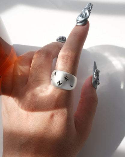 Model wearing engraved chunky copper band ring with a brushed finish and adjustable open band – front view – SWEEKU jewelry
