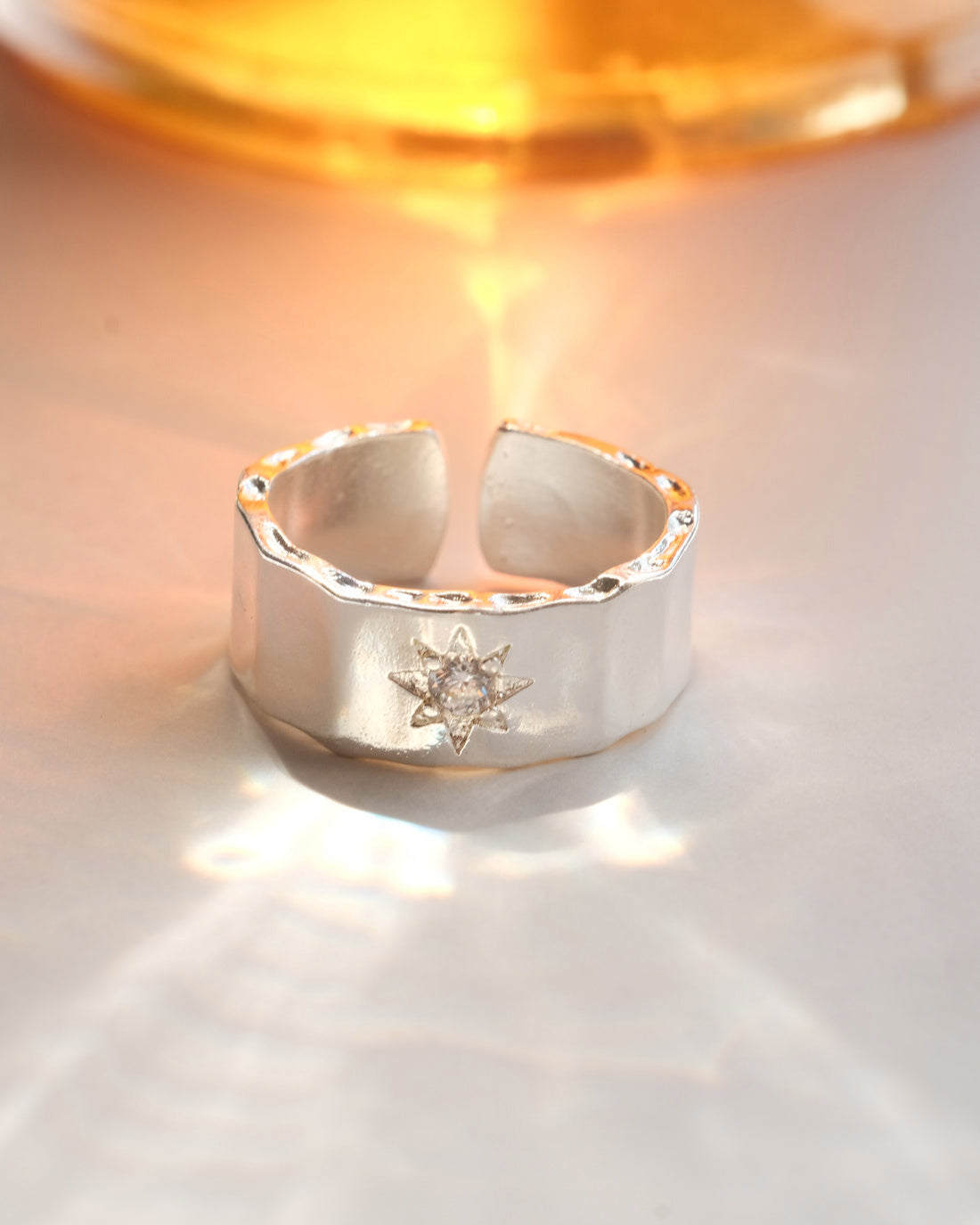 Hammered copper adjustable ring with an open band and a small polished star detail – front view – SWEEKU jewelry
