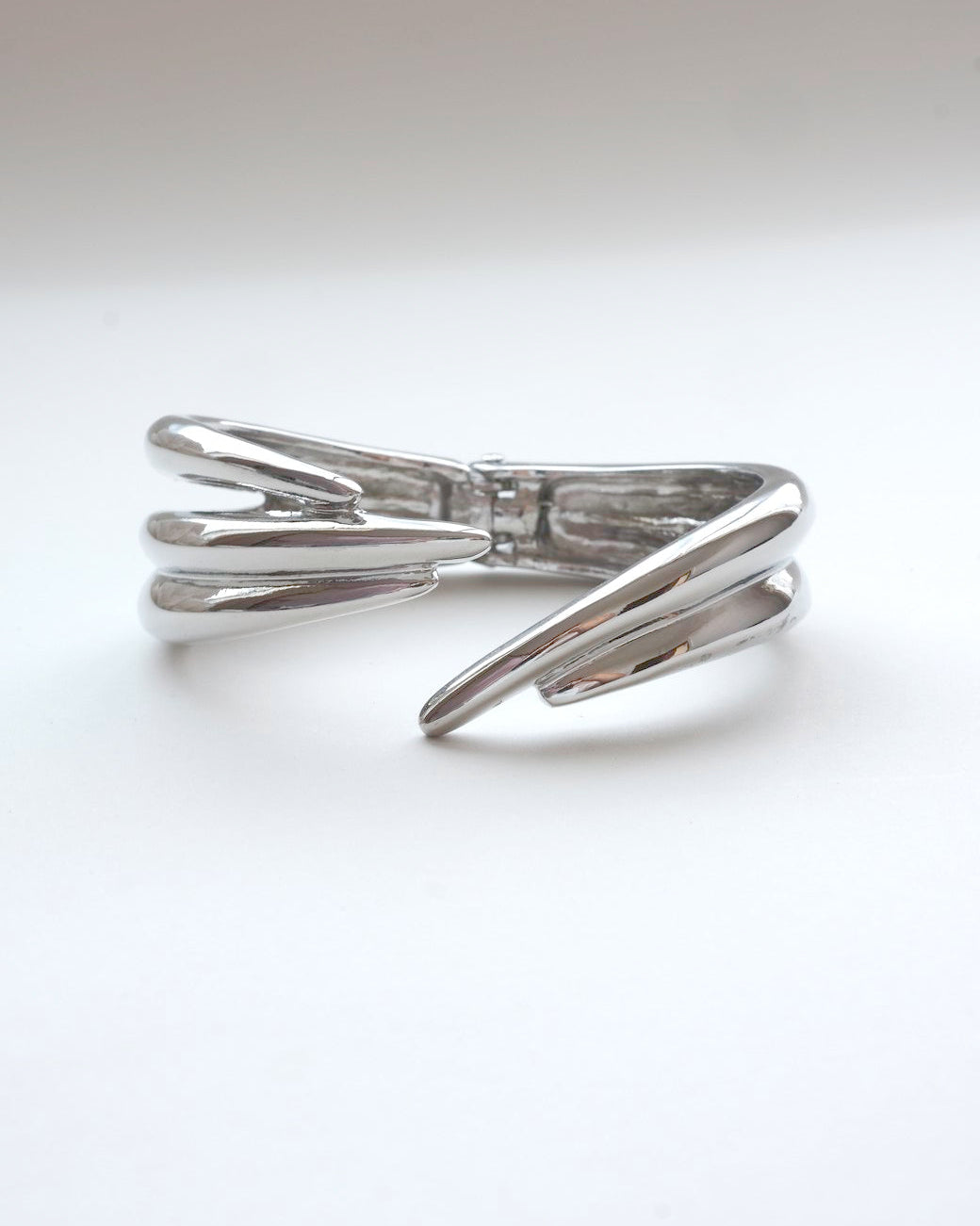 Liquid metal sculptural bracelet featuring a bold, multi-layered claw design - front view - SWEEKU jewelry