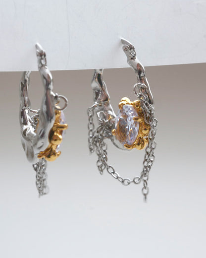 Pair of unique melting metal two-tone copper hoop earrings with dangling chains and an oval crystal - side view - SWEEKU jewelry