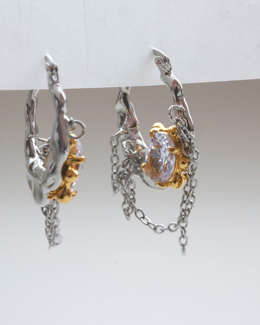 Pair of unique melting metal two-tone copper hoop earrings with dangling chains and an oval crystal - side view - SWEEKU jewelry