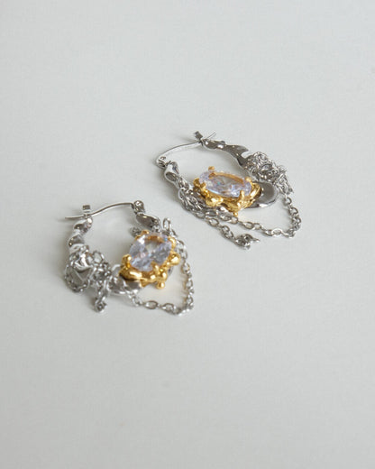 Pair of unique melting metal two-tone copper hoop earrings with dangling chains and an oval crystal - side view - SWEEKU jewelry