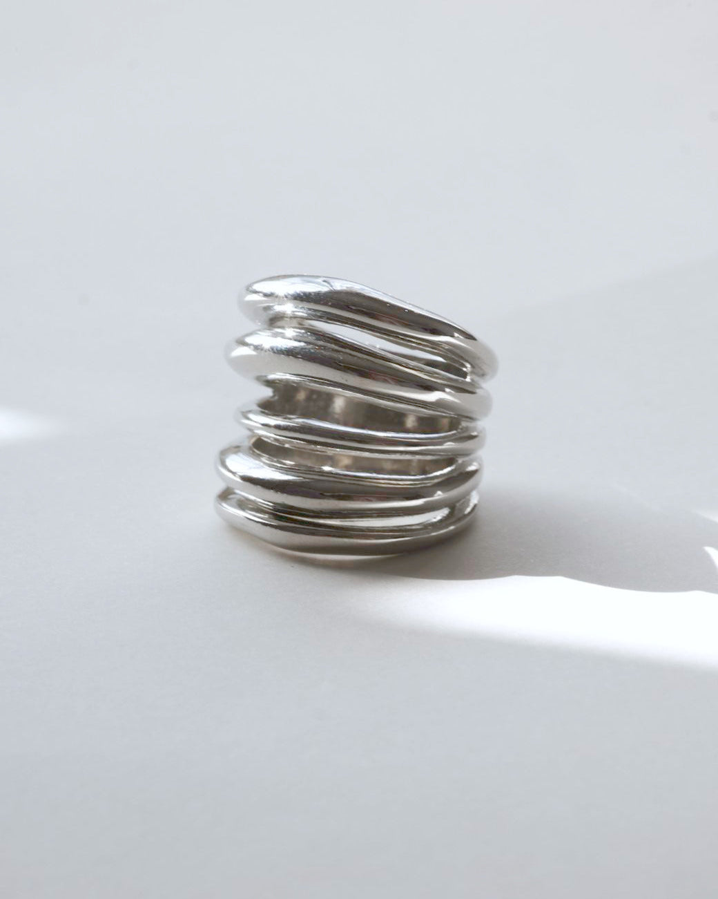 Multi-layer sculptural statement ring with a polished, stacked band design – detail view – SWEEKU jewelry
