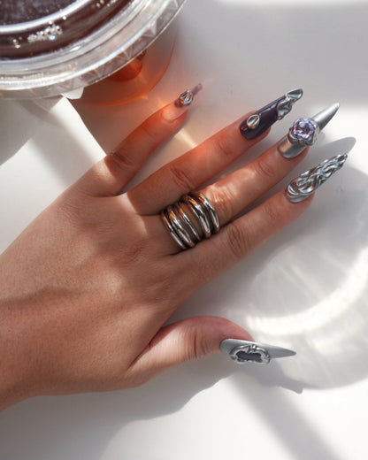 Model wearing multi-layer sculptural statement ring with a polished, stacked band design – top view – SWEEKU jewelry