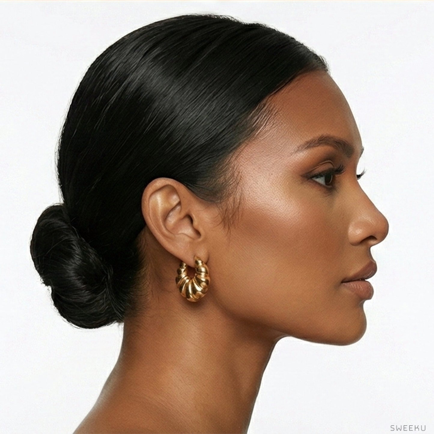 Model wearing chunky 18K gold plated croissant hoops