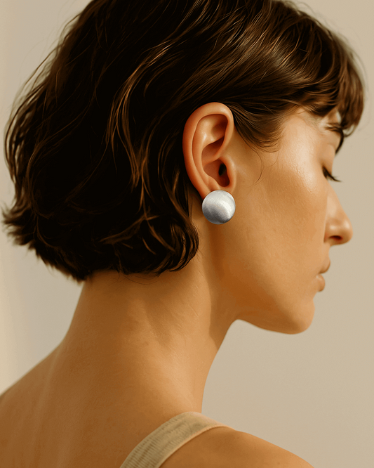 Model wearing pair of polished puffed dome copper stud earrings with 925 sterling silver posts - front view - SWEEKU jewelry