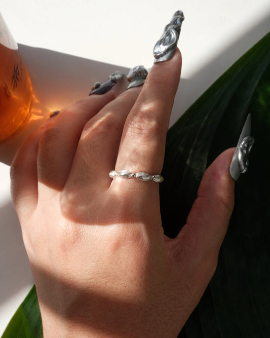 Model wearing ribbed copper adjustable ring with an open band and a small domed design – front view – SWEEKU jewelry