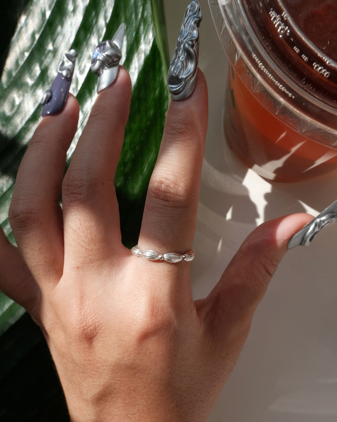 Model wearing Ribbed copper adjustable ring with an open band and a small domed design – top view – SWEEKU jewelry