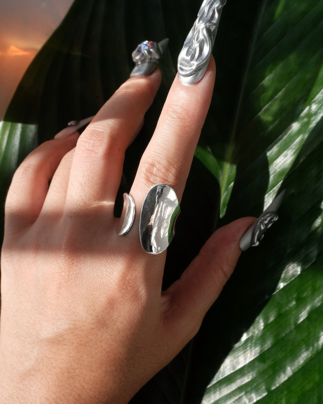 Model wearing sculptural fluid open ring with a polished finish and adjustable band – front view – SWEEKU jewelry