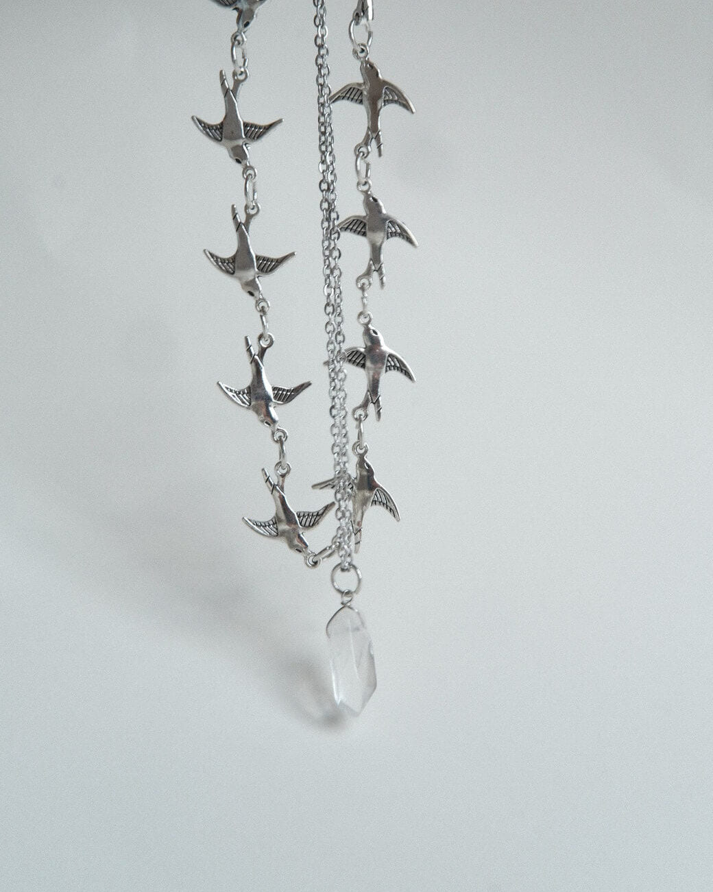 Layered necklace set with a bird chain link choker and a separate crystal pendant necklace – front view – SWEEKU jewelry