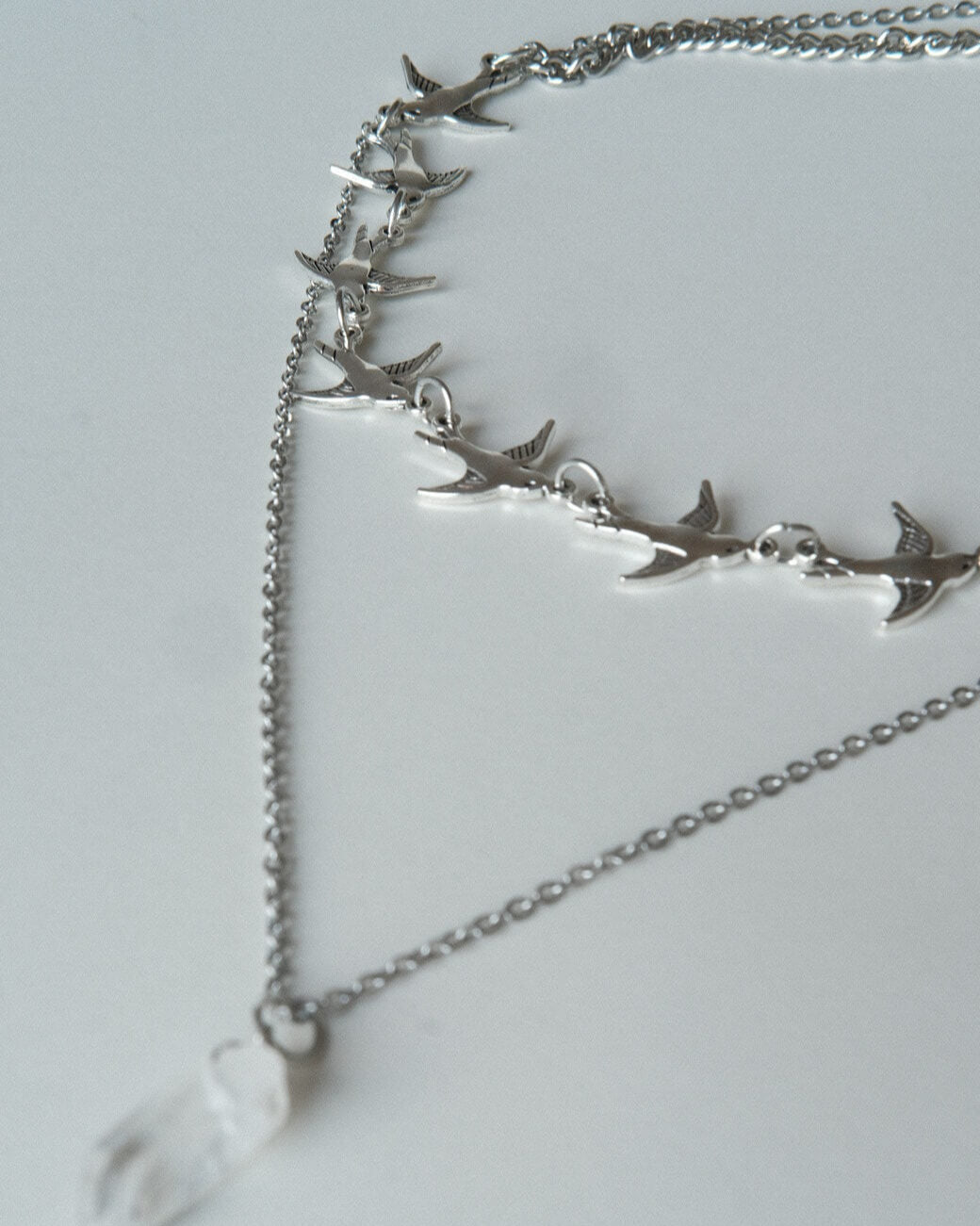 Layered necklace set with a bird chain link choker and a separate crystal pendant necklace - detail - side view - SWEEKU jewelry