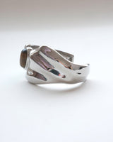 Sculptural liquid metal cuff bracelet with a polished finish and a central Tiger's Eye gemstone – side view – SWEEKU jewelry