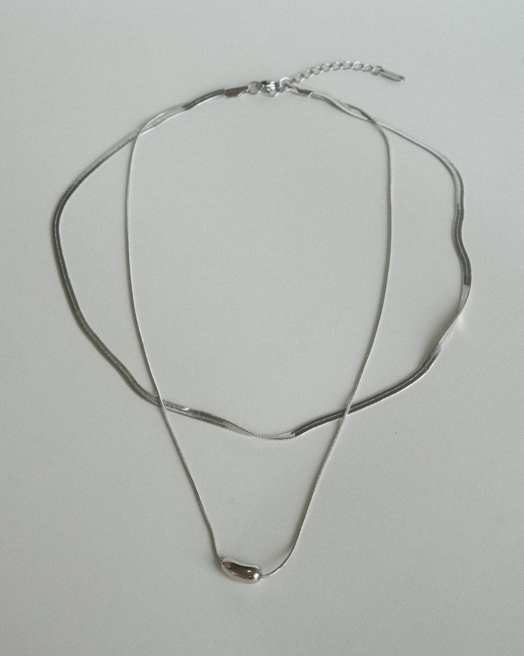 Two-layer snake chain necklace with a small, polished tear drop pendant - front view - SWEEKU jewelry
