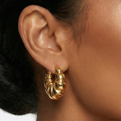 Close-up of ear showing secure fit of the gold plated waterproof croissant hoop earring