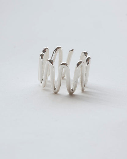 Sculptural wavy line ring with a polished, fluid design and adjustable band