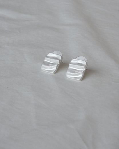 Pair of wavy rectangle copper stud earrings with silver posts and a textured, modern design - front view 2 - SWEEKU jewelry