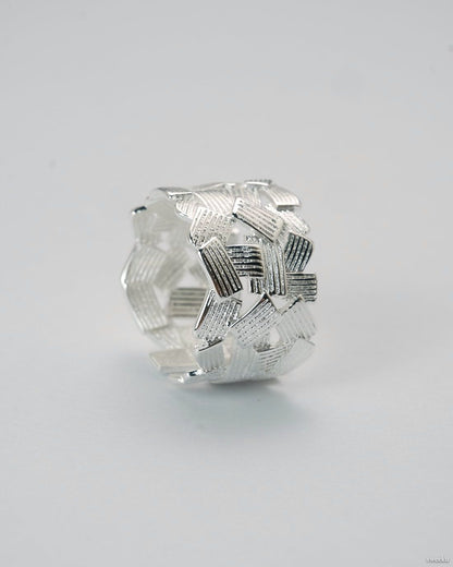Adjustable silver-plated ring with interwoven lattice design on white background
