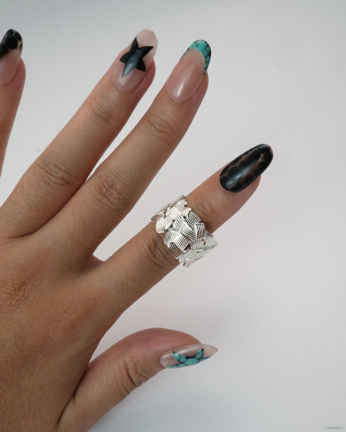 Weave Echo Ring worn on hand, bold silver woven band with polished texture